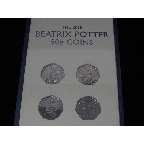 24 - Beatrix Potter 2018 50p Brilliant Uncirculated Set in fitted case; 3 x £5 coins on Numismatic Philat... 