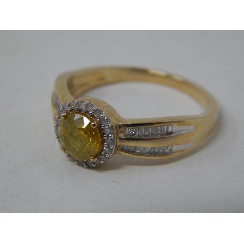 256 - 9ct Yellow Gold Ring Set with a Central Yellow Diamond Measuring 0.77cts Within a White Diamond Bord... 