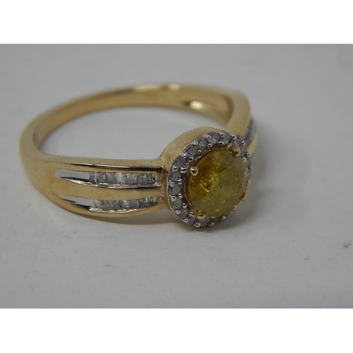 256 - 9ct Yellow Gold Ring Set with a Central Yellow Diamond Measuring 0.77cts Within a White Diamond Bord... 