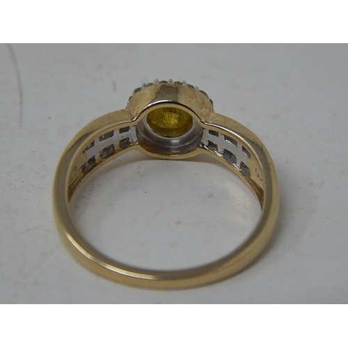 256 - 9ct Yellow Gold Ring Set with a Central Yellow Diamond Measuring 0.77cts Within a White Diamond Bord... 