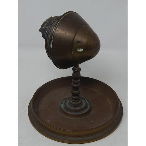 377 - WWI Exploded Shell Cap Mounted as a Paperweight Inset to Base with 1914 Penny together with a Cast B... 