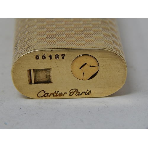 153 - CARTIER: 18ct Gold Lighter Stamped 750: Serial No: 66187: Gross weight 90g: In Red Cartier Box.