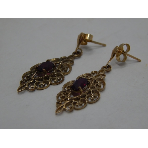 213 - 9ct Gold garnet set drop earrings. 463726