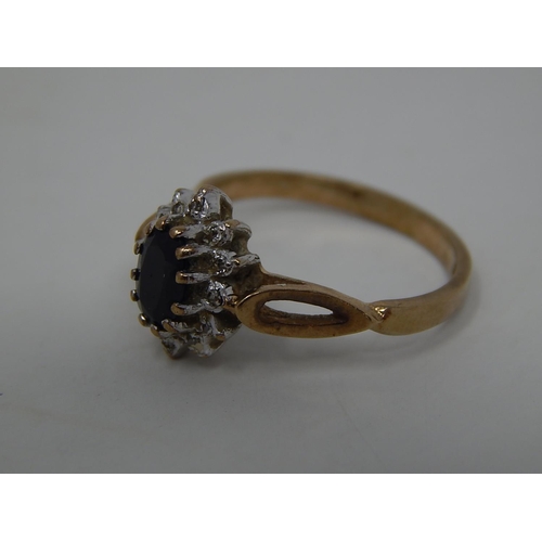 221 - 9ct gold diamond and sapphire set cluster ring. 303039