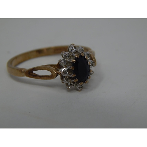 221 - 9ct gold diamond and sapphire set cluster ring. 303039