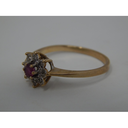 257 - 9ct gold ruby and diamond set cluster ring. 530919