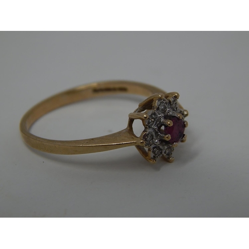 257 - 9ct gold ruby and diamond set cluster ring. 530919