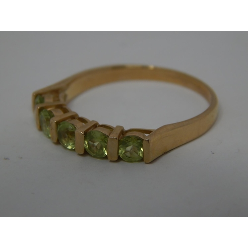 282 - 9ct gold peridot set half eternity ring. 359880