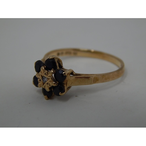 295 - 9ct gold diamond and sapphire cluster ring. 141382