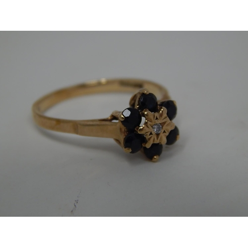 295 - 9ct gold diamond and sapphire cluster ring. 141382