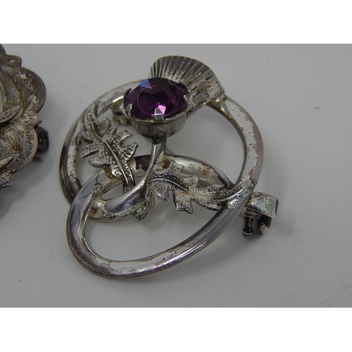 91 - 2 x Scottish Silver Brooches set with amethyst coloured stones.