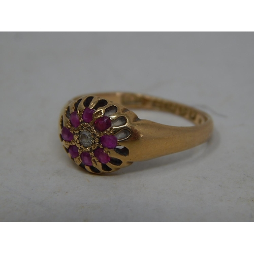 39O - 18ct Gold Ring Set With a Central Diamond & Bordered by Eight Rubies: Ring Size N: Gross weight 3.8g