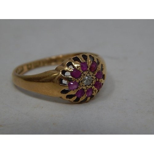 39O - 18ct Gold Ring Set With a Central Diamond & Bordered by Eight Rubies: Ring Size N: Gross weight 3.8g