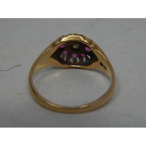 39O - 18ct Gold Ring Set With a Central Diamond & Bordered by Eight Rubies: Ring Size N: Gross weight 3.8g