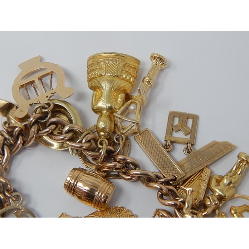 12 - 9ct Yellow Gold Charm Bracelet with Numerous 9ct & 14ct Yellow Gold Charms: Including Masonic Charms... 