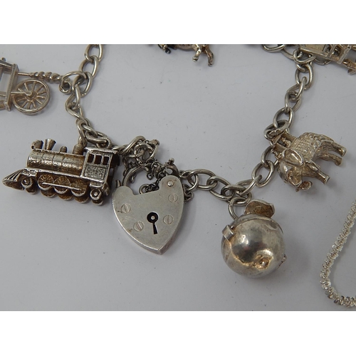 31 - Silver Charm Bracelet with Numerous Charms together with a silver bracelet & silver brooch.