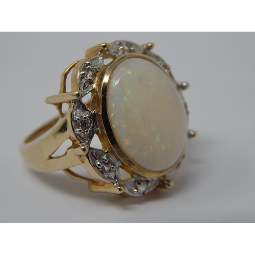 60 - HUGE Opal Ring Set with a Central Opal Measuring 16mm x 12mm within a Diamond Border Mounted in 9ct ... 