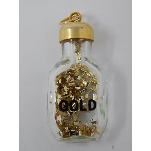 76 - 9ct Gold Topped Bottle Pendant Containing Gold.