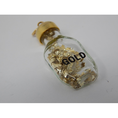 76 - 9ct Gold Topped Bottle Pendant Containing Gold.