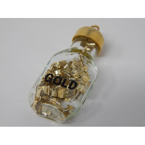 76 - 9ct Gold Topped Bottle Pendant Containing Gold.