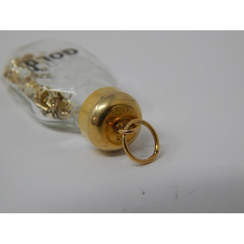 76 - 9ct Gold Topped Bottle Pendant Containing Gold.