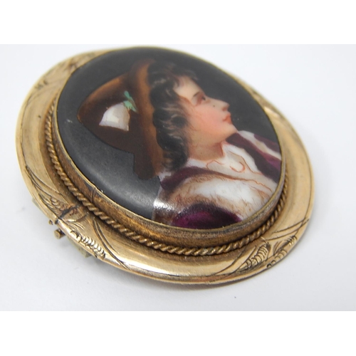 93 - An Antique Hand Painted Porcelain Portrait Brooch of an Alpine Boy in Costume within a Gold Mount.