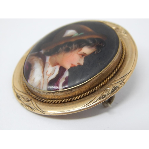 93 - An Antique Hand Painted Porcelain Portrait Brooch of an Alpine Boy in Costume within a Gold Mount.