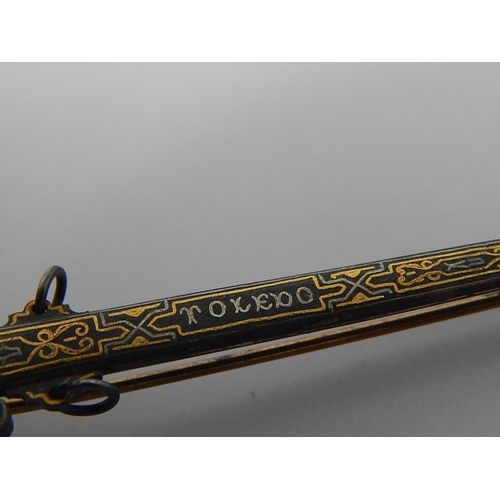 94 - A Toledo Sword Brooch with Pique Decoration. 8.5cm