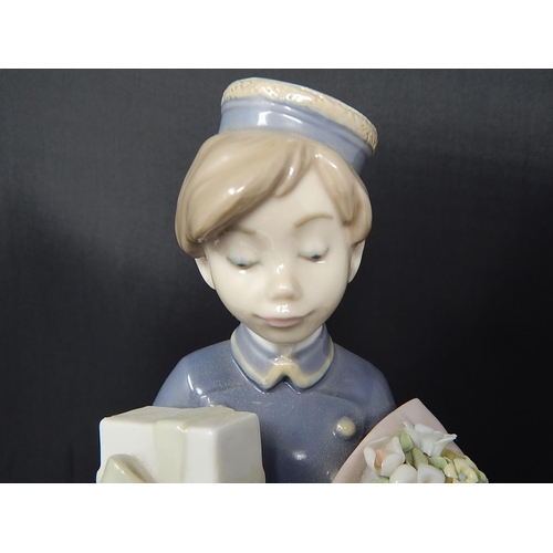 735 - LLADRO Figure of a Bellboy with Chocolates & Flowers: Height 26cm