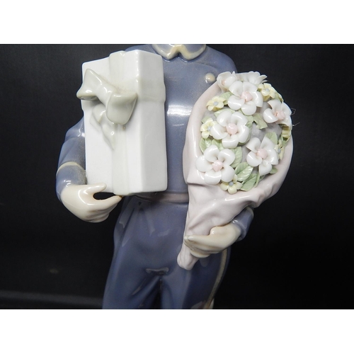 735 - LLADRO Figure of a Bellboy with Chocolates & Flowers: Height 26cm