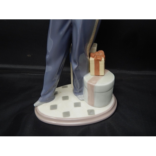 735 - LLADRO Figure of a Bellboy with Chocolates & Flowers: Height 26cm