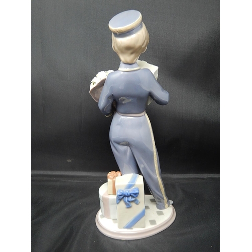 735 - LLADRO Figure of a Bellboy with Chocolates & Flowers: Height 26cm