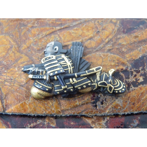 688 - Japanese Purse. The Yellow & White Metal Clasp formed as a Samurai Warrior. Measures 11cm x 9cm