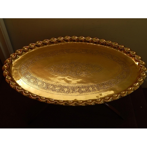 660 - Large Moroccan Brass Tray Top Table. The Oval Brass Tray with Engraved Decoration. Sitting on Foldin... 