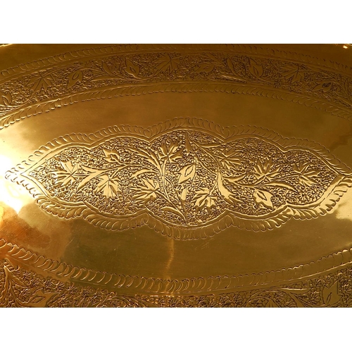 660 - Large Moroccan Brass Tray Top Table. The Oval Brass Tray with Engraved Decoration. Sitting on Foldin... 