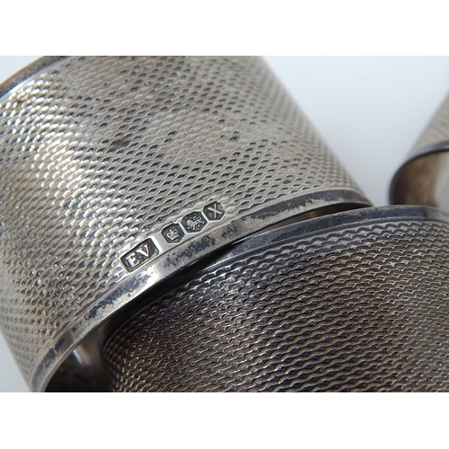 255 - 3 x Hallmarked Silver Engine Turned Napkin Rings with Blank Cartouches together with a Silver Hallma... 