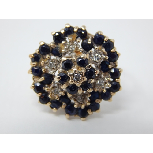 26 - 9ct Yellow Gold Flower Head Ring Inset with Bands of Diamonds & Sapphires: Ring Size R