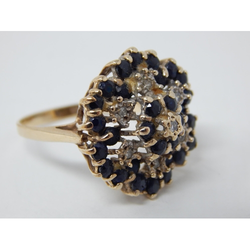 26 - 9ct Yellow Gold Flower Head Ring Inset with Bands of Diamonds & Sapphires: Ring Size R