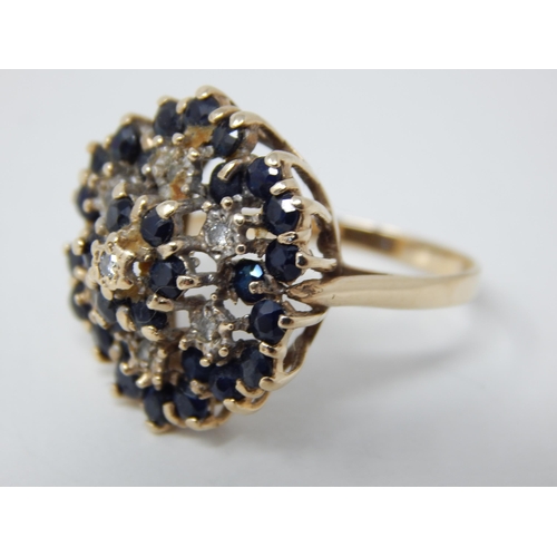 26 - 9ct Yellow Gold Flower Head Ring Inset with Bands of Diamonds & Sapphires: Ring Size R