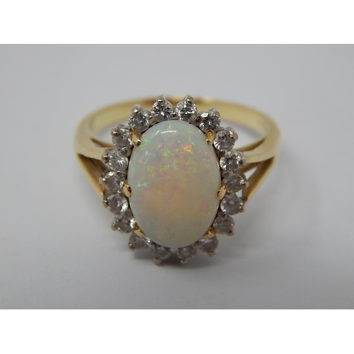 43 - 14ct Gold Ring Set with a Central Opal Estimated at 3.00cts within a Border of 18 Diamonds: Ring Siz... 