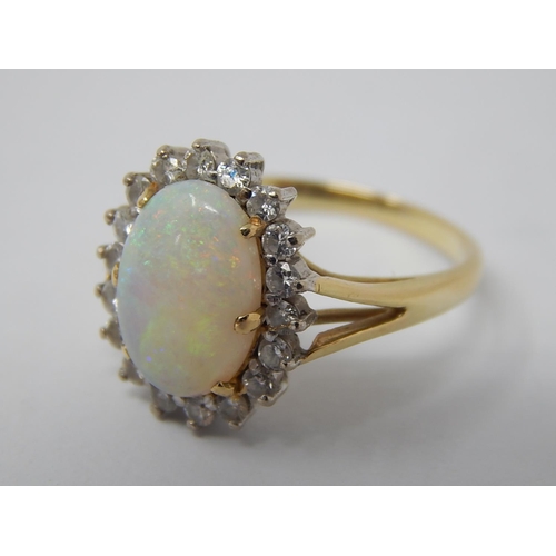 43 - 14ct Gold Ring Set with a Central Opal Estimated at 3.00cts within a Border of 18 Diamonds: Ring Siz... 