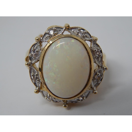 45 - HUGE Opal Ring Set with a Central Opal Measuring 16mm x 12mm within a Diamond Border Mounted in 9ct ... 
