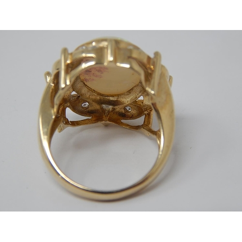 45 - HUGE Opal Ring Set with a Central Opal Measuring 16mm x 12mm within a Diamond Border Mounted in 9ct ... 