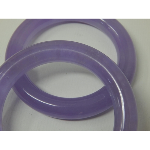 338 - Two Chinese Lilac Jade Bangles (2)