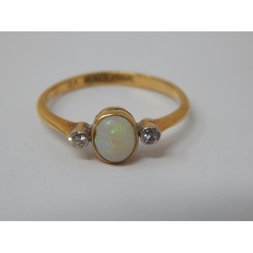 378 - 18ct Yellow Gold & Platinum Ring Set with a central Opal flanked by a Diamond either side: Ring Size... 