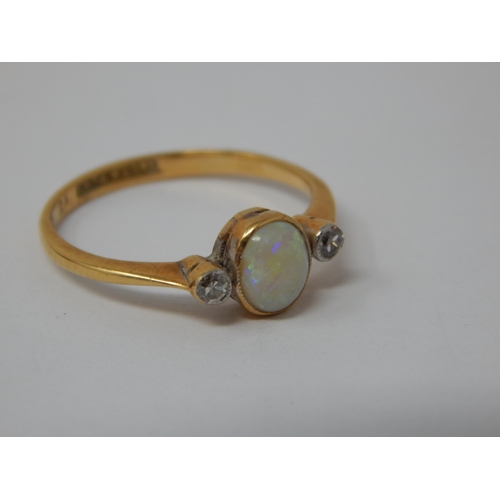 378 - 18ct Yellow Gold & Platinum Ring Set with a central Opal flanked by a Diamond either side: Ring Size... 