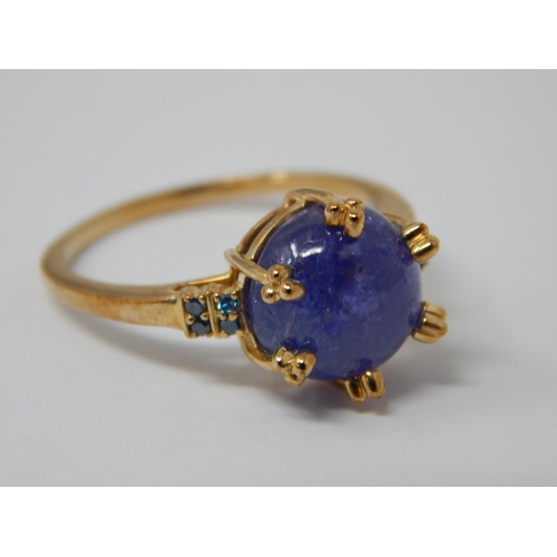 446 - 9ct Yellow Gold Ring Set with a Central Tanzanite Cabochon with Blue Diamond Accents: Total 5.58cts:... 