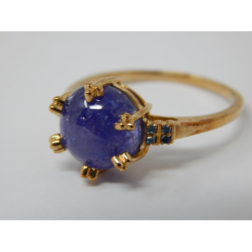 446 - 9ct Yellow Gold Ring Set with a Central Tanzanite Cabochon with Blue Diamond Accents: Total 5.58cts:... 