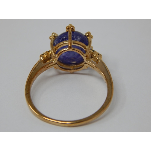 446 - 9ct Yellow Gold Ring Set with a Central Tanzanite Cabochon with Blue Diamond Accents: Total 5.58cts:... 