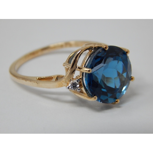 450 - 9ct Ring Set with a Central Marambaia Blue Topaz with White Zircon Accents: Topaz Weight 6.25cts: Ri... 